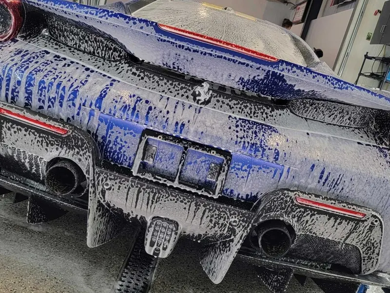Foam wash on a coated rear bumper during maintenance detailing